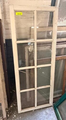 24 IN. W X 53 IN. VINTAGE WOOD WINDOW SASH WITH 8-LITE TRUE DIVIDED GLASS. PAINTED WHITE FINISH.