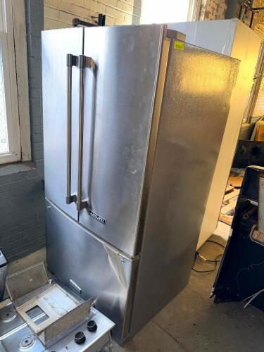 KITCHENAID STAINLESS STEEL FRENCH DOOR REFRIGERATOR WITH BOTTOM FREEZER, EXTERNAL ICE AND WATER DISPENSER, ELECTRONIC TEMPERATURE CONTROLS, ADJUSTABLE GLASS SHELVES, AND HUMIDITY-CONTROLLED CRISPERS. LOWER FREEZER DRAWER HAS VISIBLE COSMETIC DAMAGE.