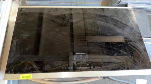 KITCHENAID 30-INCH ELECTRIC SMOOTHTOP COOKTOP WITH BLACK CERAMIC GLASS SURFACE, FIVE RADIANT COOKING ELEMENTS, STAINLESS STEEL TRIM, AND ELECTRONIC TOUCH CONTROLS.
