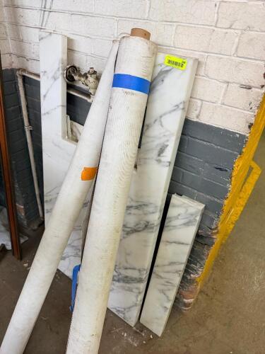 ASSORTED NATURAL STONE SLABS AND REMNANTS INCLUDING MARBLE AND OTHER POLISHED STONE PIECES.