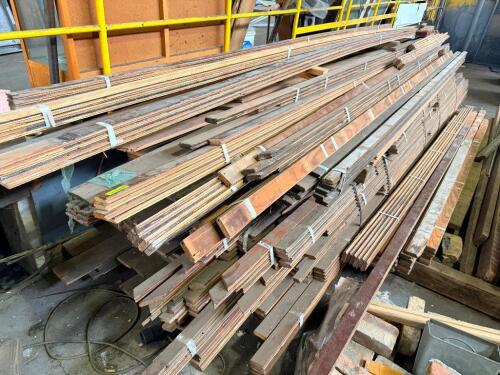 LOT OF RECLAIMED HARDWOOD TRIM, MOLDING, AND MILLWORK PIECES. LOT INCLUDES ASSORTED LENGTHS OF DECORATIVE TRIM, BASEBOARD, CASING, AND OTHER FINISHED WOOD MOLDING WITH VARIOUS PROFILES AND FINISHES.