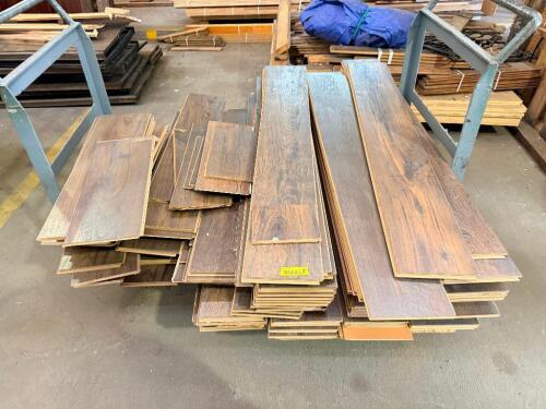 LOT OF ENGINEERED WOOD FLOORING. LOT INCLUDES ASSORTED TONGUE-AND-GROOVE PLANKS WITH DARK WOOD-GRAIN FINISH IN MIXED LENGTHS.