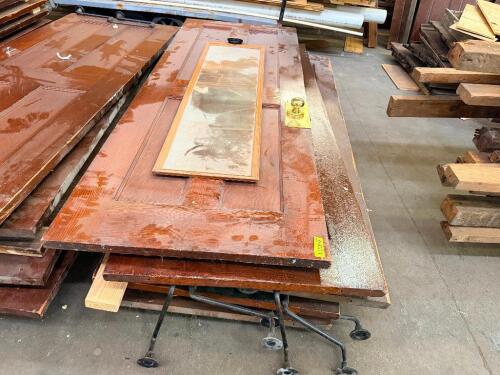 (5) RECLAIMED WOOD DOORS AND DOOR COMPONENTS. LOT INCLUDES ASSORTED SOLID WOOD PANEL DOORS, GLASS DOOR INSERTS, HARDWARE, AND RELATED ARCHITECTURAL SALVAGE.