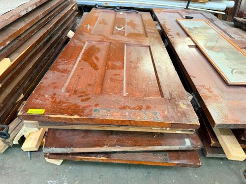 (5) RECLAIMED WOOD DOORS AND DOOR COMPONENTS. LOT INCLUDES ASSORTED SOLID WOOD PANEL DOORS, GLASS DOOR INSERTS, HARDWARE, AND RELATED ARCHITECTURAL SALVAGE.