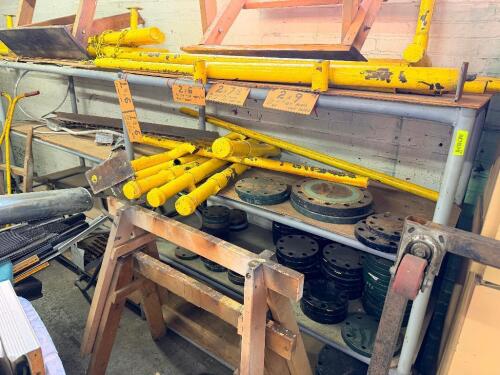 ASSORTED INDUSTRIAL PIPELINE COMPONENTS, STEEL PIPE SUPPORTS, FLANGES, WOOD SAWHORSES, AND MATERIAL HANDLING PARTS. INCLUDES MULTIPLE SIZES OF PIPE STANDS AND STACKS OF BLIND FLANGES