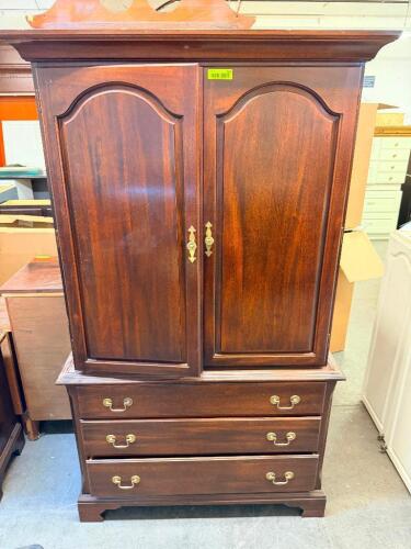 TRADITIONAL WOOD ARMOIRE ENTERTAINMENT CABINET. FEATURES DOUBLE DOORS WITH INTERIOR STORAGE COMPARTMENT ABOVE THREE LOWER DRAWERS. IDEAL FOR CLOTHING, LINENS, OR ENTERTAINMENT STORAGE.