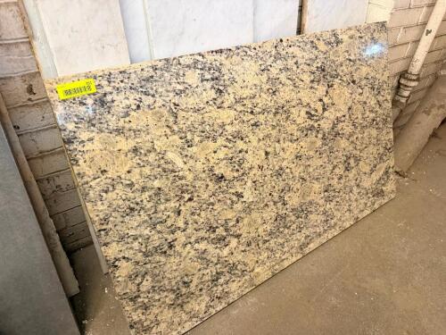 48" POLISHED GRANITE SLAB REMNANT. FEATURES A CREAM, TAN, GRAY, AND BLACK SPECKLED NATURAL STONE PATTERN WITH A HIGH-GLOSS POLISHED FINISH