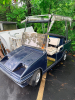 WESTERN ELECTRIC GOLF CART WITH WINDSHIELD, FOLDING CANVAS TOP, HEADLIGHTS, TWO-PERSON BENCH SEAT, REAR BAG PLATFORM, AND WHITE STEEL WHEELS. SELLER STATES BATTERY IS BAD BUT HE DOES HAVE A REPLACEMENT LITHIUM BATTERY FOR THIS CART. - 2