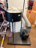 2 HP DUST COLLECTION SYSTEM WITH COLLECTION BAG, FLEXIBLE DUST HOSE, BLOWER ASSEMBLY, STEEL STAND, AND PORTABLE BASE.