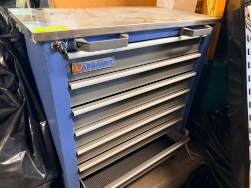 HEAVY-DUTY ROLLING TOOL CABINET WITH STAINLESS STEEL WORK TOP AND MULTIPLE LOCKING DRAWERS.