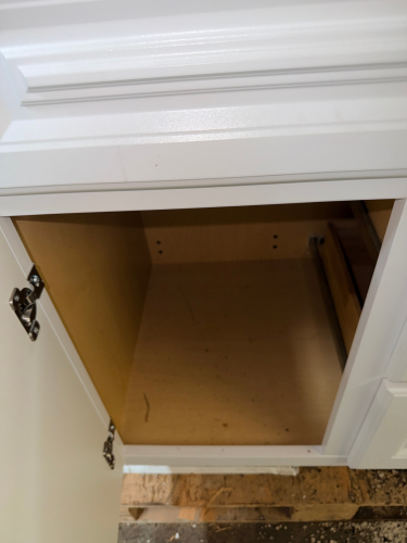 WHITE SINGLE-SINK BATHROOM VANITY WITH INTEGRATED SOLID SURFACE TOP.