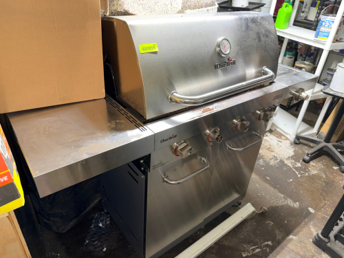 STAINLESS STEEL LIQUID PROPANE GAS GRILL WITH SIDE SHELVES, DOUBLE ACCESS DOORS, WARMING RACK, CAST IRON COOKING GRATES, LID-MOUNTED TEMPERATURE GAUGE, AND MULTIPLE MAIN BURNERS