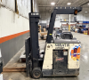 CROWN STRATIS STAND-UP ELECTRIC REACH FORKLIFT WITH OVERHEAD GUARD, SIDE STANCE OPERATOR COMPARTMENT, REACH MAST, AND 24" LOAD CENTER RATING.
