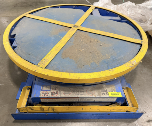 PNEUMATIC ROTARY TURNTABLE WITH LOW-PROFILE BASE, HEAVY-DUTY STEEL ROTATING PLATFORM, AND INTEGRATED AIR CYLINDER.