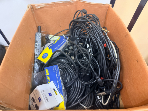 ASSORTED AUDIO, VIDEO, AND CAMERA ACCESSORIES INCLUDING CABLES, POWER EXTENSION CORDS, LENS WIPES, AND ASSORTED CONNECTIVITY COMPONENTS.