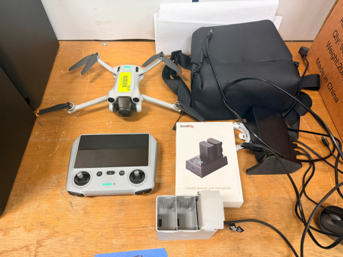DJI MINI 3 PRO FOLDABLE CAMERA DRONE PACKAGE WITH DJI RC REMOTE CONTROLLER, SHOULDER BAG, DUAL BATTERY CHARGER, SMALLRIG BATTERY AND CHARGER KIT, AND ACCESSORIES.