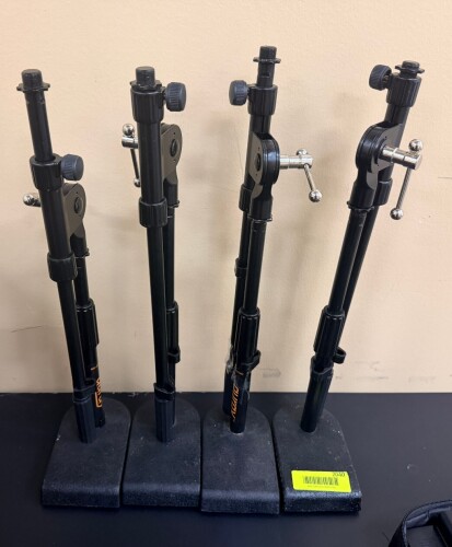 ADJUSTABLE STUDIO LIGHT STANDS WITH WEIGHTED BASES AND TILT HEADS. LOT INCLUDES (4) MATCHING TELESCOPING METAL STANDS WITH 5/8" MOUNTING STUDS.