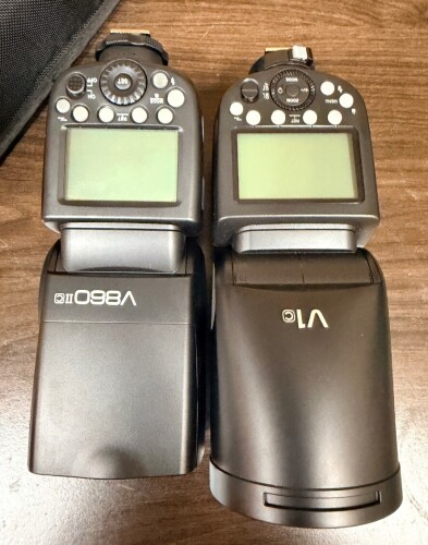 PAIR OF SHOE-MOUNT CAMERA FLASHES. INCLUDES (1) GODOX V860III-C FOR CANON AND (1) GODOX V1-C FOR CANON.