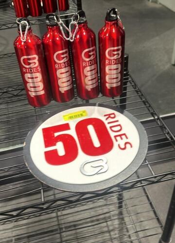 (4) WATER BOTTLES AND (1) SIGN AS SHOWN