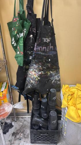 (1) ASSORTED LOT OF PAINTING APRONS, REUSABLE CUPS, AND CLEANING CLOTHS