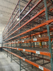 (34) SECTIONS OF 25 FT TALL UPRIGHTS AND 8 FT LONG CROSS BEAMS OF TEAR DROP PALLET RACKING. CONFIGURED AS (2) BACK-TO-BACK RUNS OF (17) SECTIONS EACH. INCLUDES (36) UPRIGHTS, ORANGE STEP BEAMS, GREEN UPRIGHTS, HEAVY-DUTY WIRE DECKING, AND STABILIZING TIE - 9