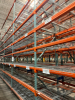 (34) SECTIONS OF 25 FT TALL UPRIGHTS AND 8 FT LONG CROSS BEAMS OF TEAR DROP PALLET RACKING. CONFIGURED AS (2) BACK-TO-BACK RUNS OF (17) SECTIONS EACH. INCLUDES (36) UPRIGHTS, ORANGE STEP BEAMS, GREEN UPRIGHTS, HEAVY-DUTY WIRE DECKING, AND STABILIZING TIE - 11