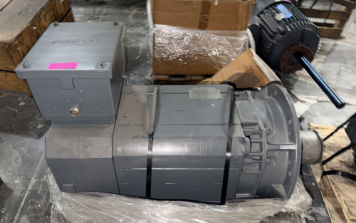 LARGE INDUSTRIAL AC ELECTRIC MOTOR WITH FLANGE MOUNT, INTEGRATED TERMINAL BOX, AND HEAVY-DUTY CAST HOUSING. NAMEPLATE IS PRESENT BUT ILLEGIBLE