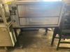 BAKERS PRIDE SINGLE DECK GAS PIZZA OVEN. STAINLESS STEEL EXTERIOR, STONE DECKS, INDEPENDENT DOORS, AND ADJUSTABLE TOP/BOTTOM HEAT CONTROL. UNIT IS MOUNTED ON A STEEL STAND WITH CASTERS - 2