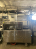 STAINLESS STEEL MOBILE CONCESSION FOOD CART WITH ENCLOSED STORAGE, OVERHEAD DISPLAY FRAME, SERVING SHELF, THREE PAN WELLS, DOUBLE BASIN HAND SINK, LOCKING CASH DRAWER, AND ROLLING CASTERS. UNIT FEATURES A STAINLESS STEEL CONSTRUCTION WITH VINYL SKIRTING