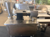STAINLESS STEEL ELECTRIC AUTOMATIC DUMPLING / RAVIOLI FORMING MACHINE WITH STUFFING HOPPER, DOUGH HOPPER, FORMING ROLLER ASSEMBLY, CONVEYOR DISCHARGE, AND LOCKING SWIVEL CASTERS. UNIT FEATURES ADJUSTABLE STUFFING VOLUME CONTROL. - 9