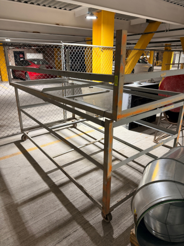 HEAVY-DUTY WELDED STEEL INDUSTRIAL STORAGE CART WITH LARGE OPEN FRAME CONSTRUCTION, MULTIPLE HORIZONTAL SUPPORT RAILS, TWO-TIER STORAGE CONFIGURATION, AND CASTER WHEELS.
