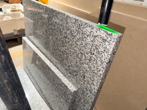 (2) POLISHED GRANITE COUNTERTOP / STONE SLABS WITH GRAY, WHITE, AND BLACK SPECKLED NATURAL STONE PATTERN. RECTANGULAR CUT PIECES WITH POLISHED FACES AND FINISHED EDGES.
