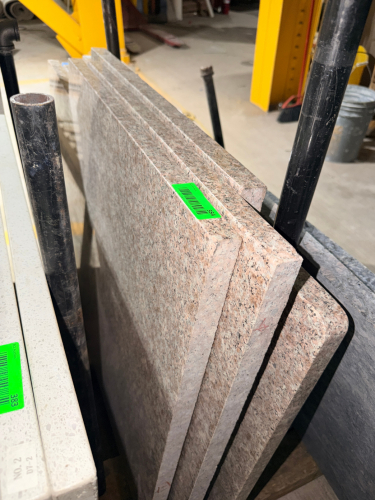 (4) PINK / GRAY SPECKLED GRANITE COUNTERTOP SLABS WITH POLISHED SURFACES AND FINISHED EDGES. MATCHING NATURAL STONE PIECES INCLUDE RECTANGULAR SECTIONS AND A NARROWER PIECE WITH ROUNDED CORNERS