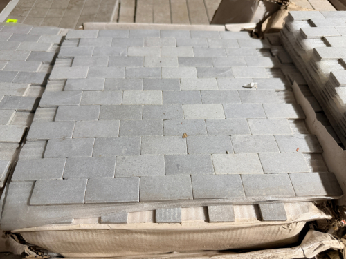 (13) BOXES OF DRIFTWOOD STONE MOSAIC TILE CONSISTING OF RECTANGULAR GRAY LIMESTONE PIECES MOUNTED ON MESH-BACKED SHEETS IN A STAGGERED BRICK PATTERN.
