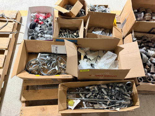 PALLET OF ASSORTED ELECTRICAL AND CONSTRUCTION HARDWARE LOT CONSISTING OF METAL CONDUIT FITTINGS, PIPE/CONDUIT HANGERS, STRAPS, CLAMPS, BRACKETS, FASTENERS, BOLTS, NUTS, WASHERS, AND MISCELLANEOUS GALVANIZED HARDWARE. CONTENTS ARE MIXED SIZES AND TYPES AN