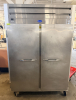 RANDELL TWO-SECTION COMMERCIAL REACH-IN FREEZER WITH STAINLESS STEEL EXTERIOR, TWO SOLID HINGED DOORS, DIGITAL TEMPERATURE CONTROL, TOP-MOUNTED REFRIGERATION SYSTEM, ADJUSTABLE INTERIOR SHELF SUPPORTS, WIRE SHELVING, AND CASTERS.