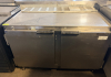 TWO-DOOR COMMERCIAL UNDERCOUNTER REFRIGERATOR WITH STAINLESS STEEL TOP, STAINLESS STEEL INTERIOR, TWO SOLID HINGED DOORS, WIRE SHELVING, REAR VENTILATION, AND CASTERS.