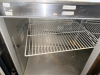 TWO-DOOR COMMERCIAL UNDERCOUNTER REFRIGERATOR WITH STAINLESS STEEL TOP, STAINLESS STEEL INTERIOR, TWO SOLID HINGED DOORS, WIRE SHELVING, REAR VENTILATION, AND CASTERS. - 4
