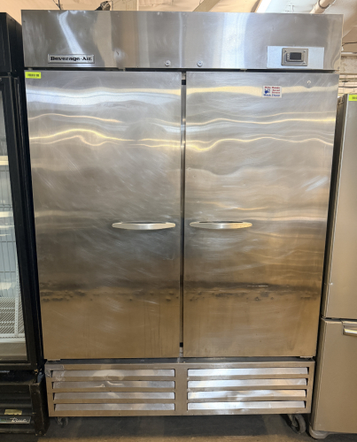 BEVERAGE-AIR TWO-DOOR REACH-IN REFRIGERATOR WITH STAINLESS STEEL EXTERIOR, DUAL SOLID DOORS, ADJUSTABLE WIRE SHELVING, DIGITAL TEMPERATURE CONTROLLER, BOTTOM-MOUNT REFRIGERATION SYSTEM, AND CASTERS.