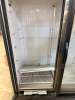 TRUE THREE-DOOR GLASS DISPLAY FREEZER WITH THREE HINGED GLASS DOORS, INTERIOR LED LIGHTING, ADJUSTABLE COATED WIRE SHELVING, BOTTOM-MOUNT DUAL COMPRESSOR REFRIGERATION SYSTEM, AND BLACK EXTERIOR FINISH. - 2