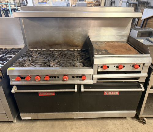 VULCAN NATURAL GAS RESTAURANT RANGE WITH SIX OPEN-TOP BURNERS, 24" GRIDDLE, TWO STANDARD OVEN BASES, HEAVY CAST-IRON BURNER GRATES, STAINLESS STEEL FRONT AND BACKSPLASH, RED BURNER CONTROLS, OVEN RACKS, AND DUAL OVEN DOORS.