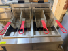 VULCAN TWIN-BATTERY FLOOR FRYER SYSTEM WITH TWO FRY POTS, FOUR FRY BASKETS WITH COATED HANDLES, STAINLESS STEEL CABINET CONSTRUCTION, INTEGRATED FILTRATION SYSTEM, DRAIN ASSEMBLY, RINSE/FILL HOSE CONNECTION, INDIVIDUAL TEMPERATURE CONTROLS, AND CASTERS. - 2