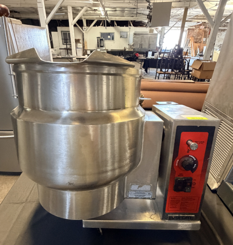 VULCAN-HART 12-GALLON TILTING STEAM-JACKETED KETTLE WITH STAINLESS STEEL CONSTRUCTION, MANUAL TILT MECHANISM, TILT-LOCK CONTROL, TEMPERATURE CONTROL, LOW-WATER INDICATOR, HEAT INDICATOR, AND INTEGRAL ELECTRIC HEATING SYSTEM. KETTLE INTERIOR IS GRADUATED T
