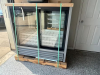 (NEW) TRUE GLASS DOOR MERCHANDISER REFRIGERATOR / COOLER WITH TWO SLIDING GLASS DOORS, BLACK EXTERIOR CABINET, INTERIOR WIRE SHELVING, AND BOTTOM-MOUNTED REFRIGERATION SYSTEM.