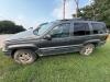 (1) DARK GRAY JEEP GRAND CHEROKEE LAREDO FOUR-DOOR SUV WITH AUTOMATIC TRANSMISSION, 4X4, ROOF RACK, TINTED REAR WINDOWS, ALLOY WHEELS, AND BLACK SEAT COVERS. VEHICLE SHOWS DIRT, CLOUDY HEADLIGHTS, EXTERIOR SCUFFS, MINOR BODY WEAR, AND A MISMATCHED STEEL F - 2