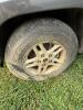 (1) DARK GRAY JEEP GRAND CHEROKEE LAREDO FOUR-DOOR SUV WITH AUTOMATIC TRANSMISSION, 4X4, ROOF RACK, TINTED REAR WINDOWS, ALLOY WHEELS, AND BLACK SEAT COVERS. VEHICLE SHOWS DIRT, CLOUDY HEADLIGHTS, EXTERIOR SCUFFS, MINOR BODY WEAR, AND A MISMATCHED STEEL F - 16