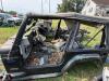 (1) BLACK JEEP WRANGLER 4.0L SPORT OFFERED AS A PROJECT, RESTORATION, OR PARTS VEHICLE. INCLUDES BODY TUB, WINDSHIELD FRAME AND GLASS, ROLL BAR ASSEMBLY, DAMAGED SOFT TOP, DASH COMPONENTS, STEERING WHEEL, BUMPERS, FENDER FLARES, SIDE STEPS, AND ASSORTED L - 3