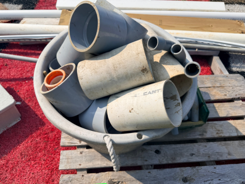 LOT OF PVC PIPE, PVC FITTINGS, ELECTRICAL ENCLOSURE, VINYL TRIM, METAL CHANNEL, AND ASSORTED BUILDING MATERIALS. SOLD AS ONE LOT.
