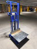MANUAL HYDRAULIC PLATFORM LIFT TRUCK WITH STEEL FRAME, LARGE METAL LOAD PLATFORM, FOOT-OPERATED HYDRAULIC LIFT, CHAIN LIFT MECHANISM, PUSH HANDLE, AND CASTER WHEELS. 1,000-LB. RATED CAPACITY - 2