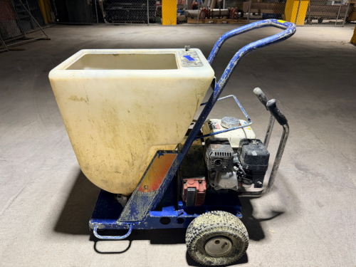 GRACO GAS-POWERED TEXTURE SPRAYER WITH LARGE MATERIAL HOPPER, PNEUMATIC DIAPHRAGM PUMP, PRESSURE GAUGES, ADJUSTABLE CONTROLS, HEAVY-DUTY STEEL CART, PNEUMATIC TIRES, AND PUSH HANDLE.